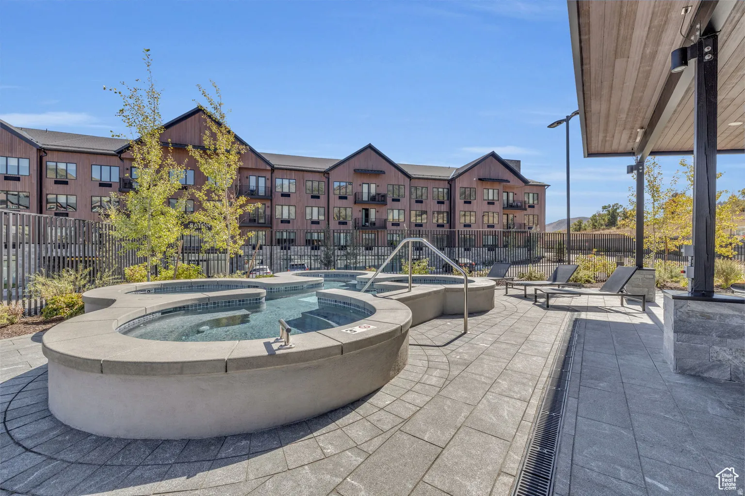 View of patio with a pool with connected hot tub