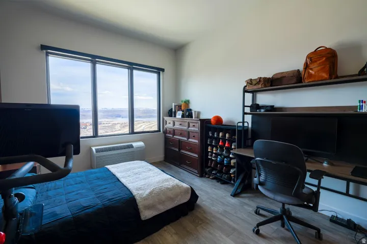 Bedroom featuring a desk and wood finished floors