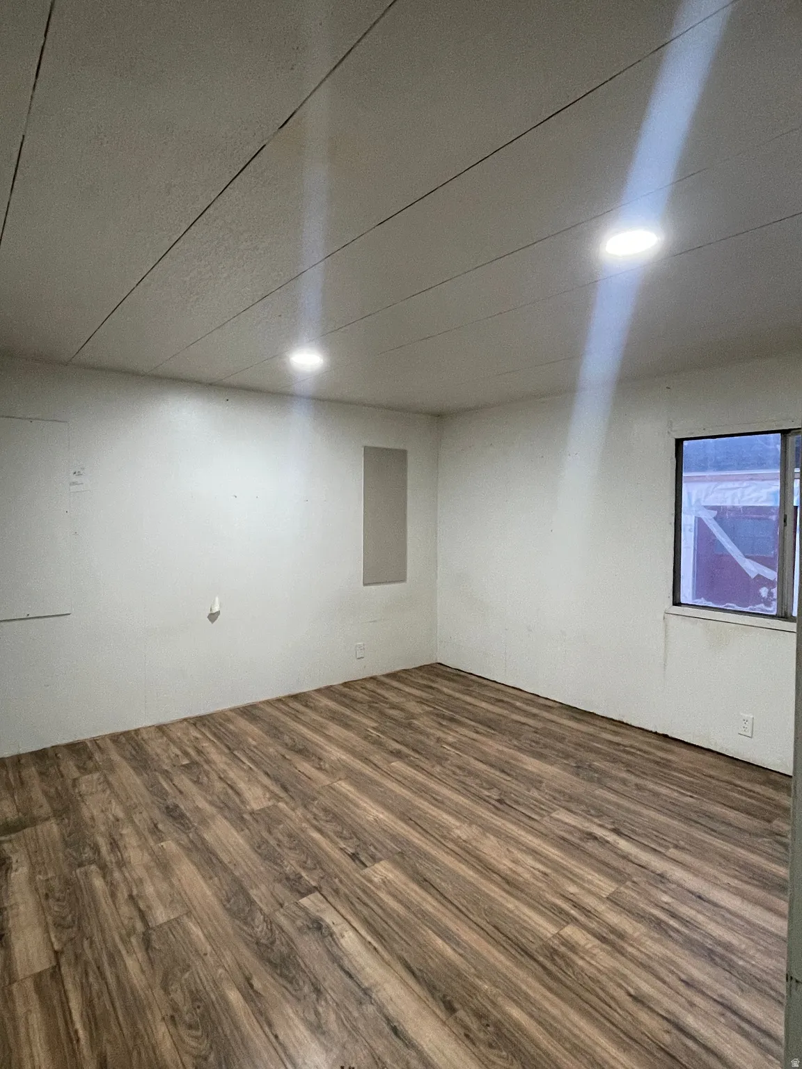Below grade area with dark wood-style flooring