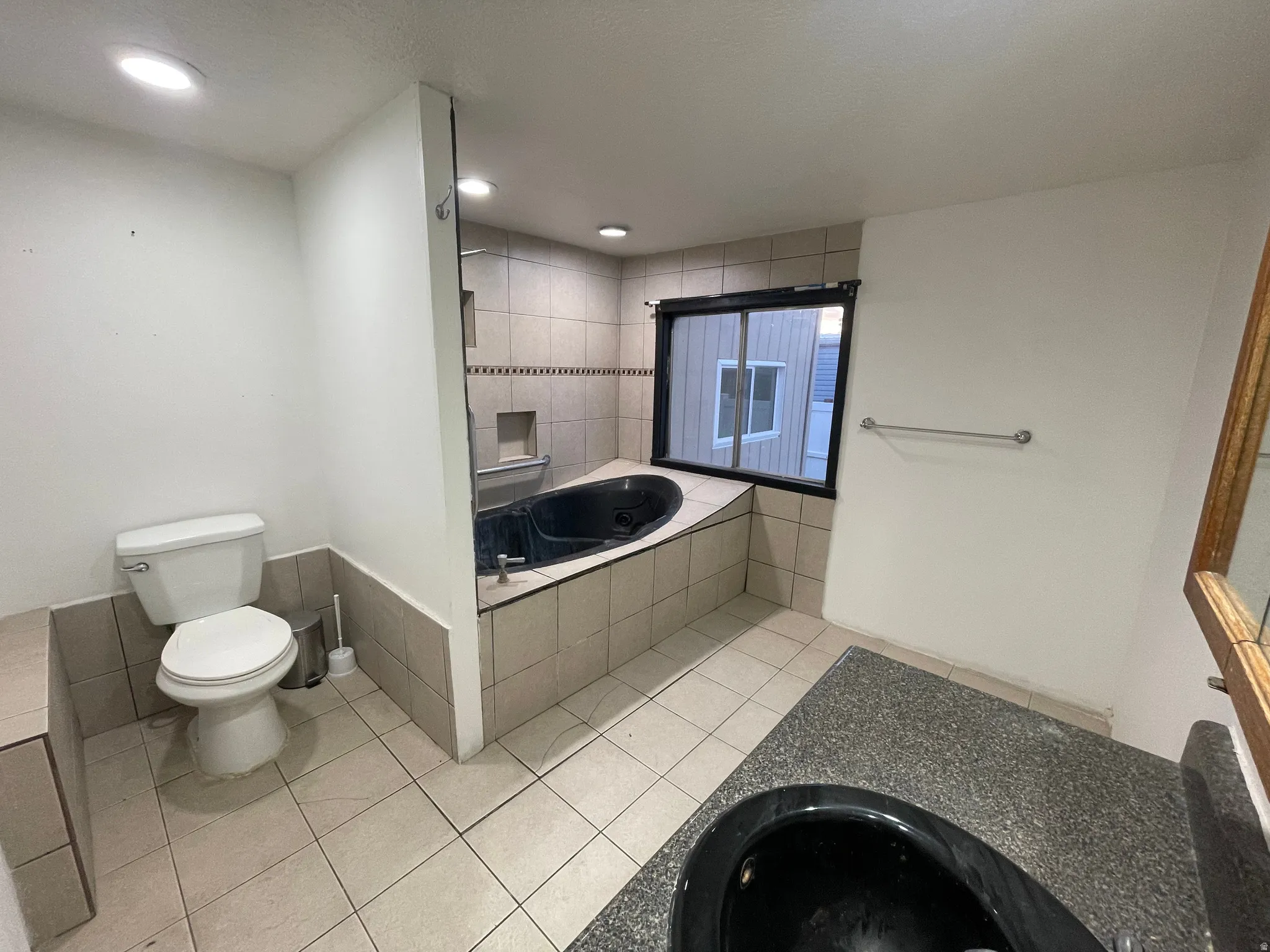 Full bath with light tile patterned floors, a garden tub, and recessed lighting