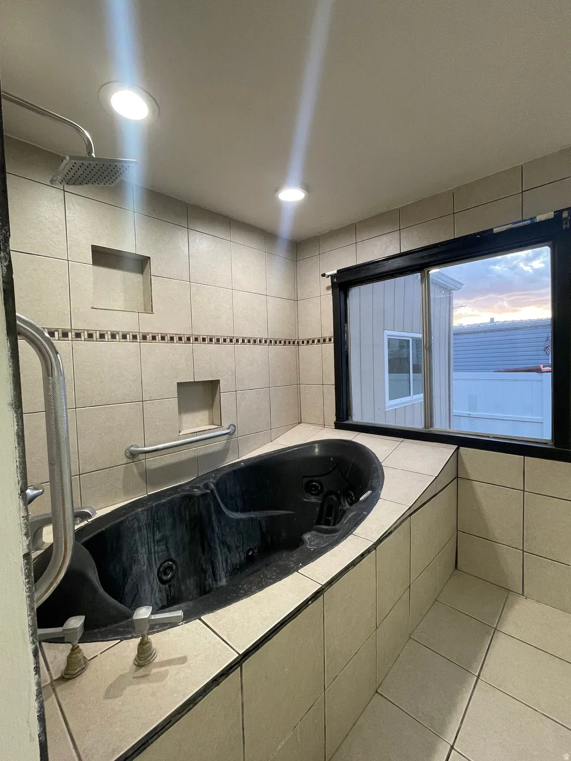 Full bath featuring a whirlpool tub, recessed lighting, light tile patterned floors, and a tile shower