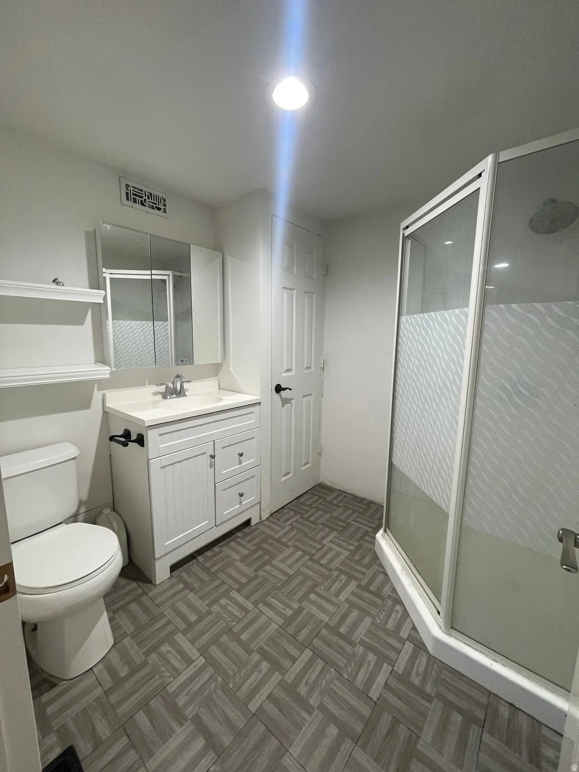 Bathroom with vanity and a shower stall