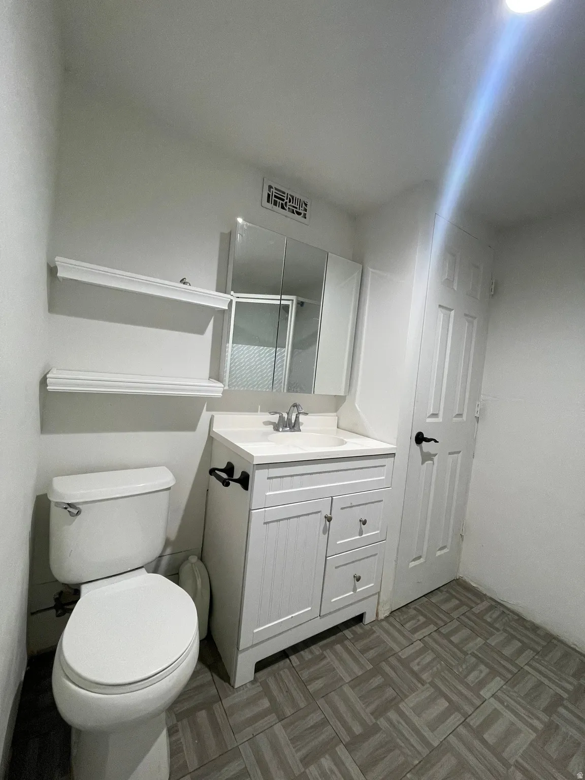 Bathroom with vanity and a shower stall