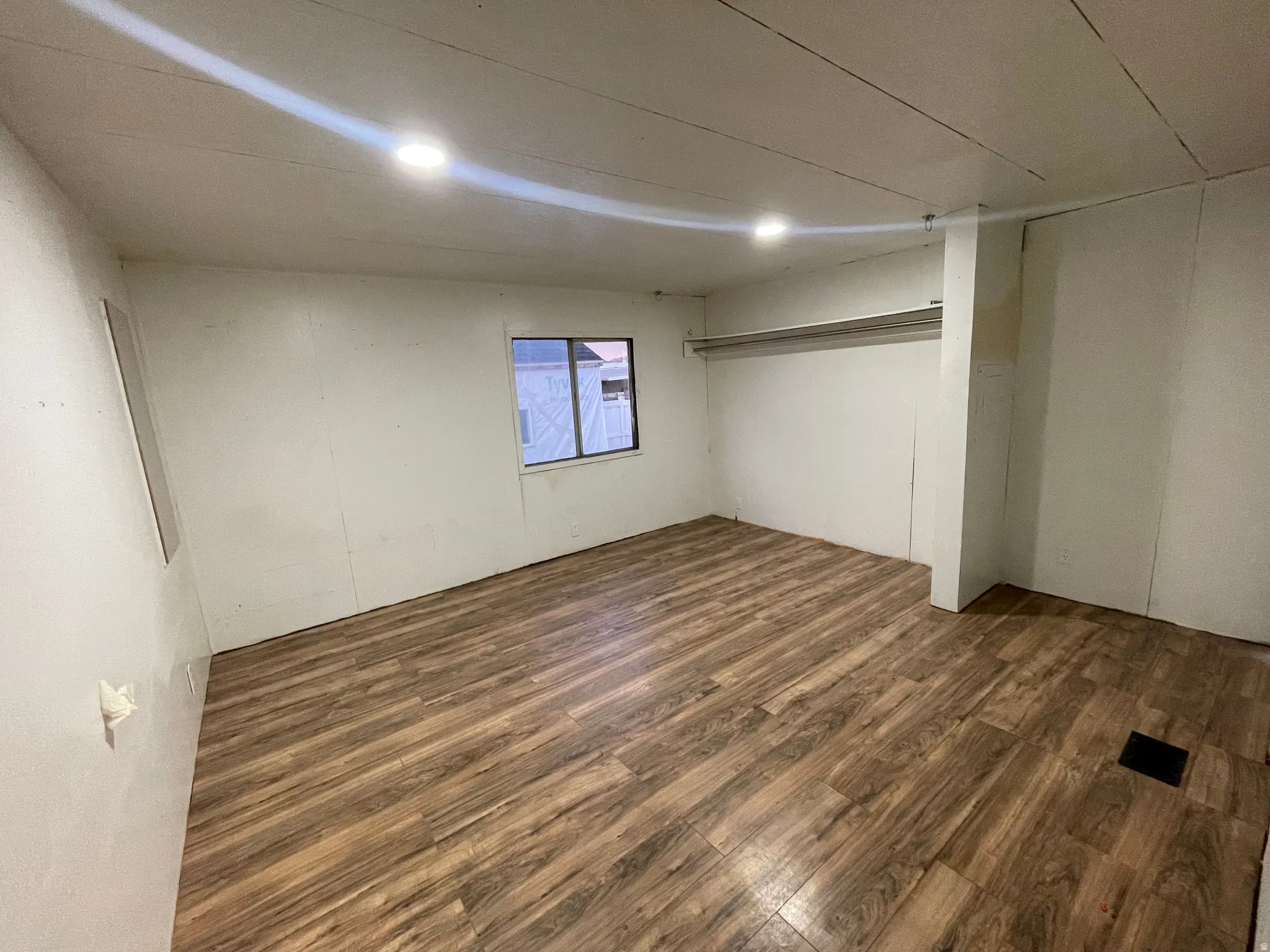 Below grade area with dark wood-style floors