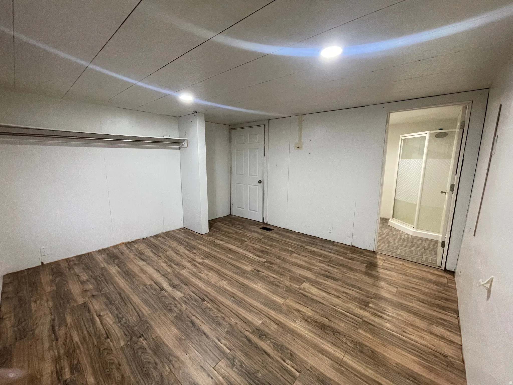 Unfurnished bedroom with dark wood-style floors