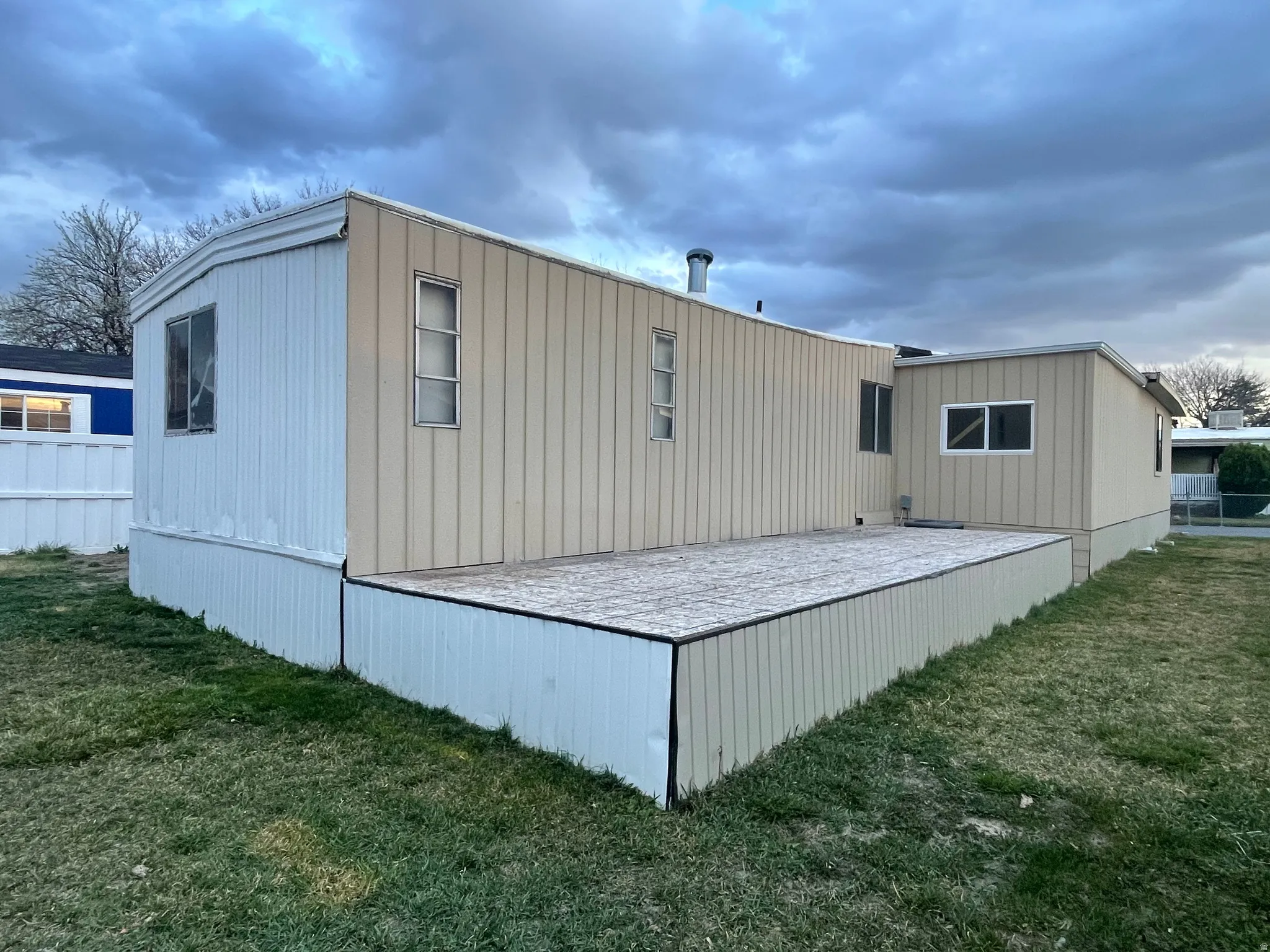 Back of property with a yard and a deck