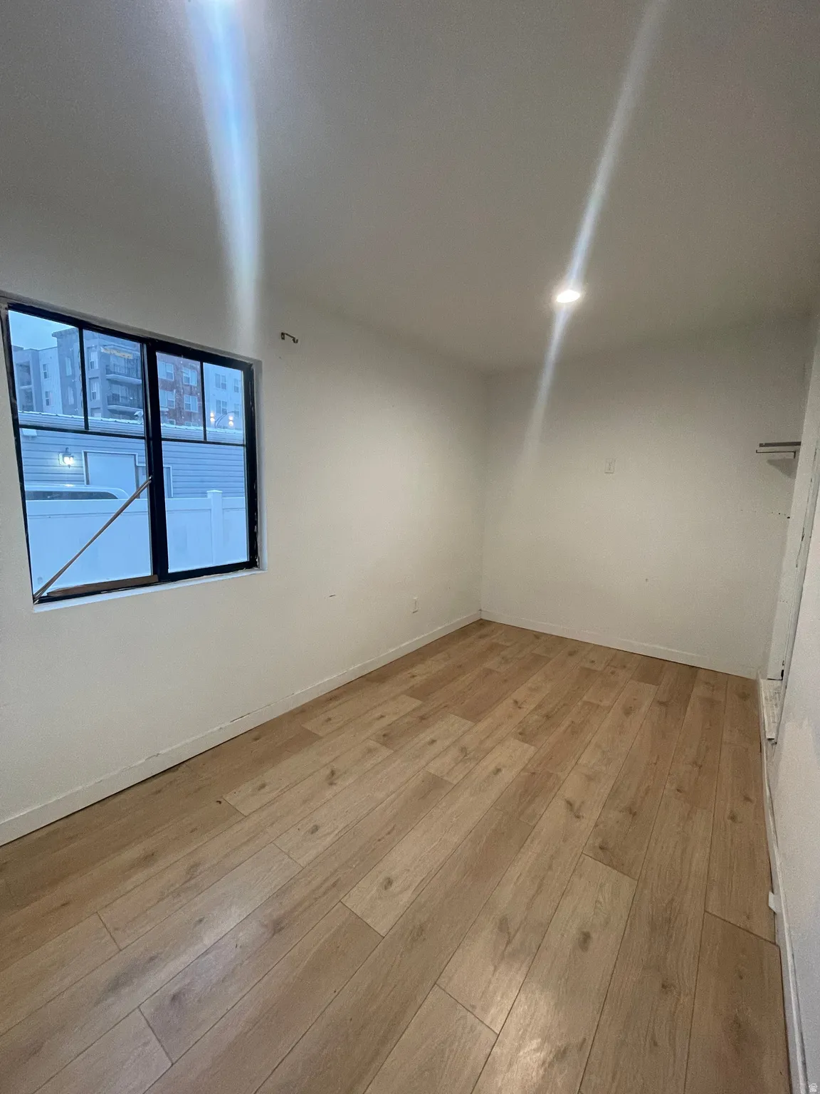 Unfurnished room featuring light wood-style floors and baseboards