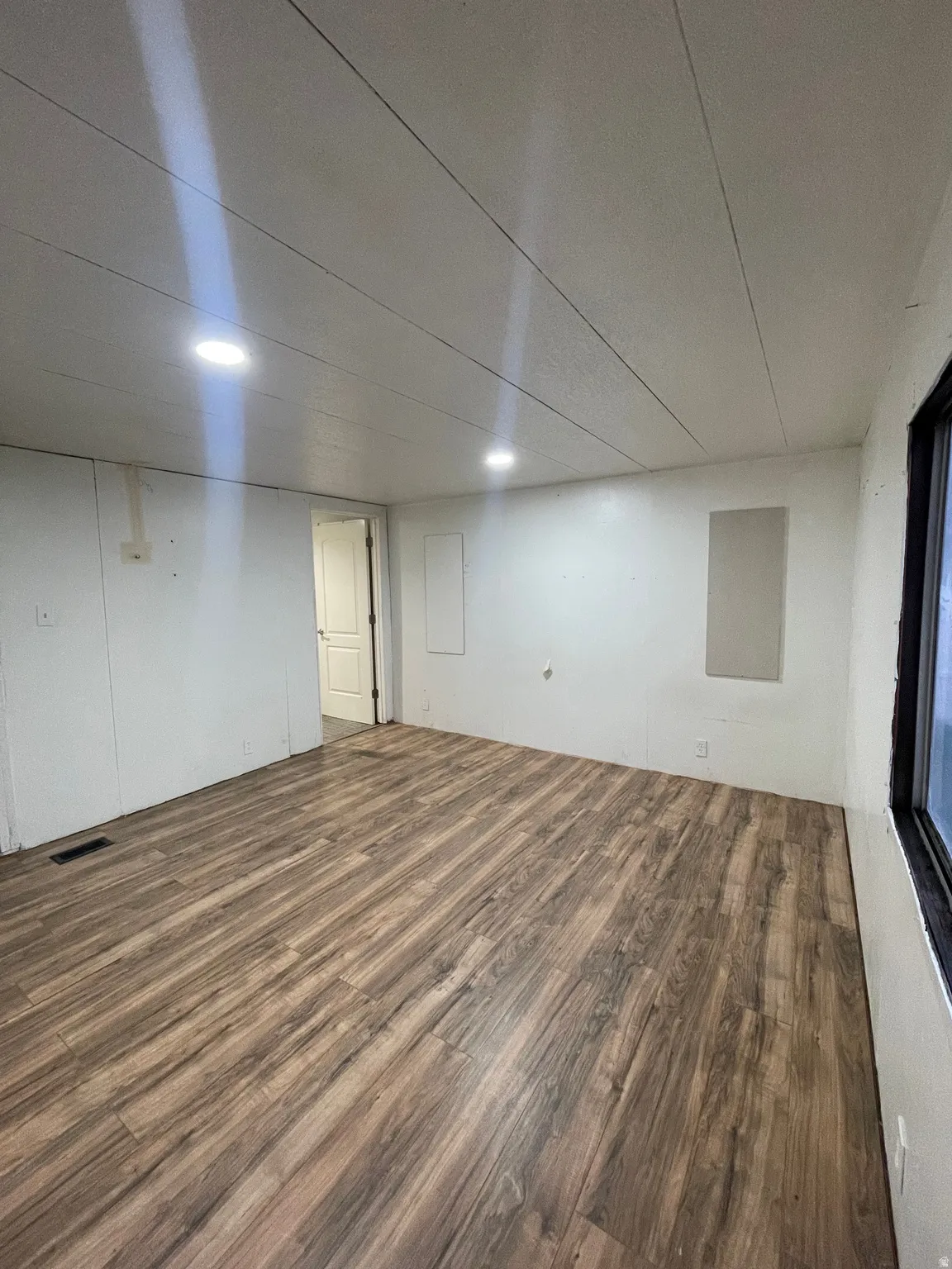 Finished basement featuring dark wood-style flooring