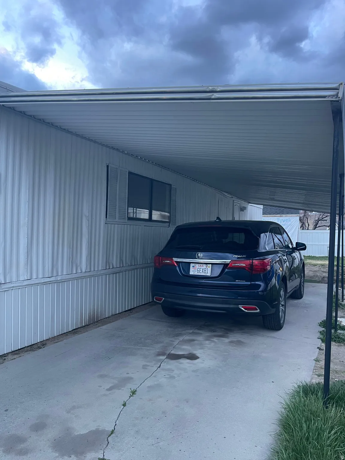 View of parking with a carport