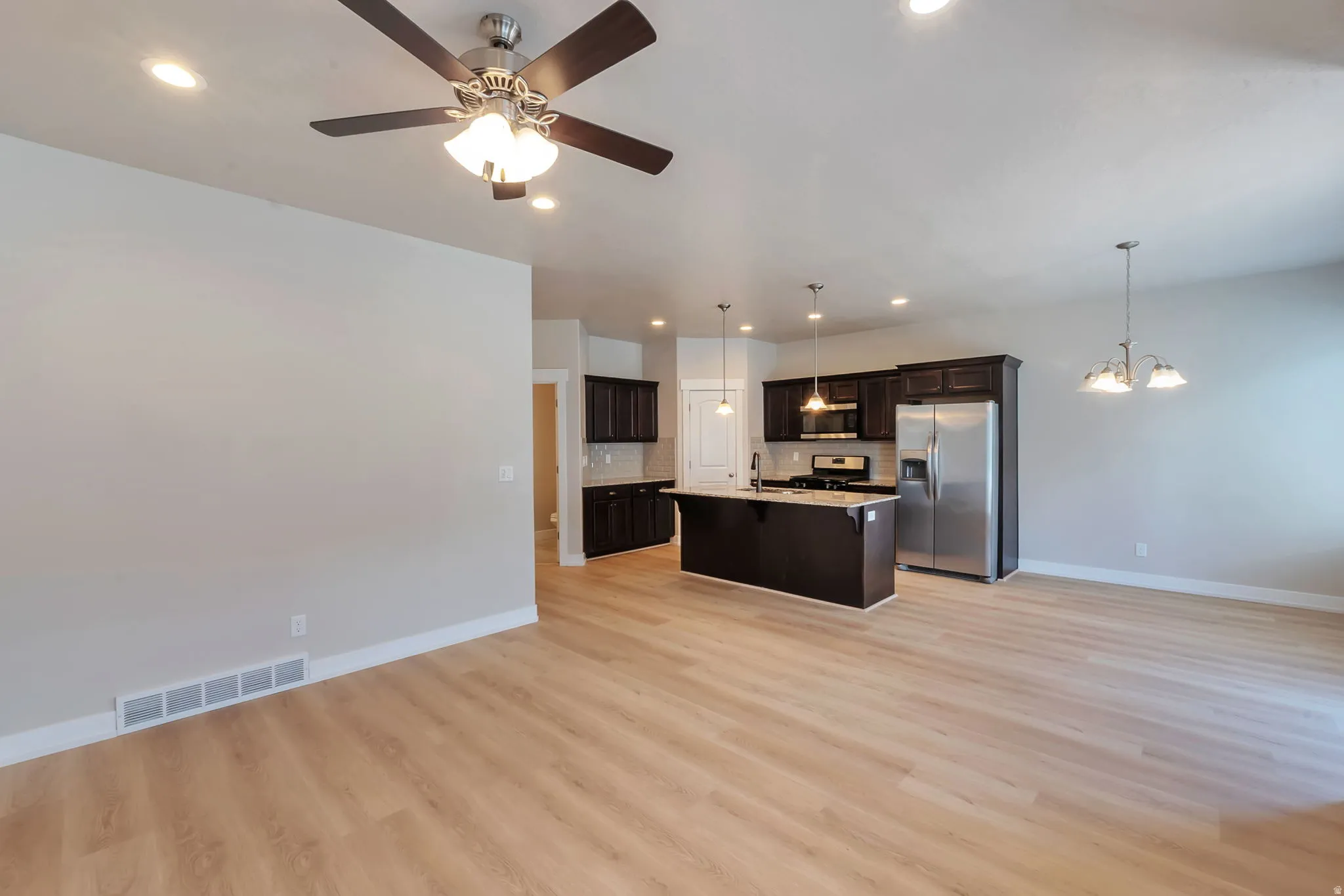 Kitchen with Island, stainless steel appliances and new LVP flooring