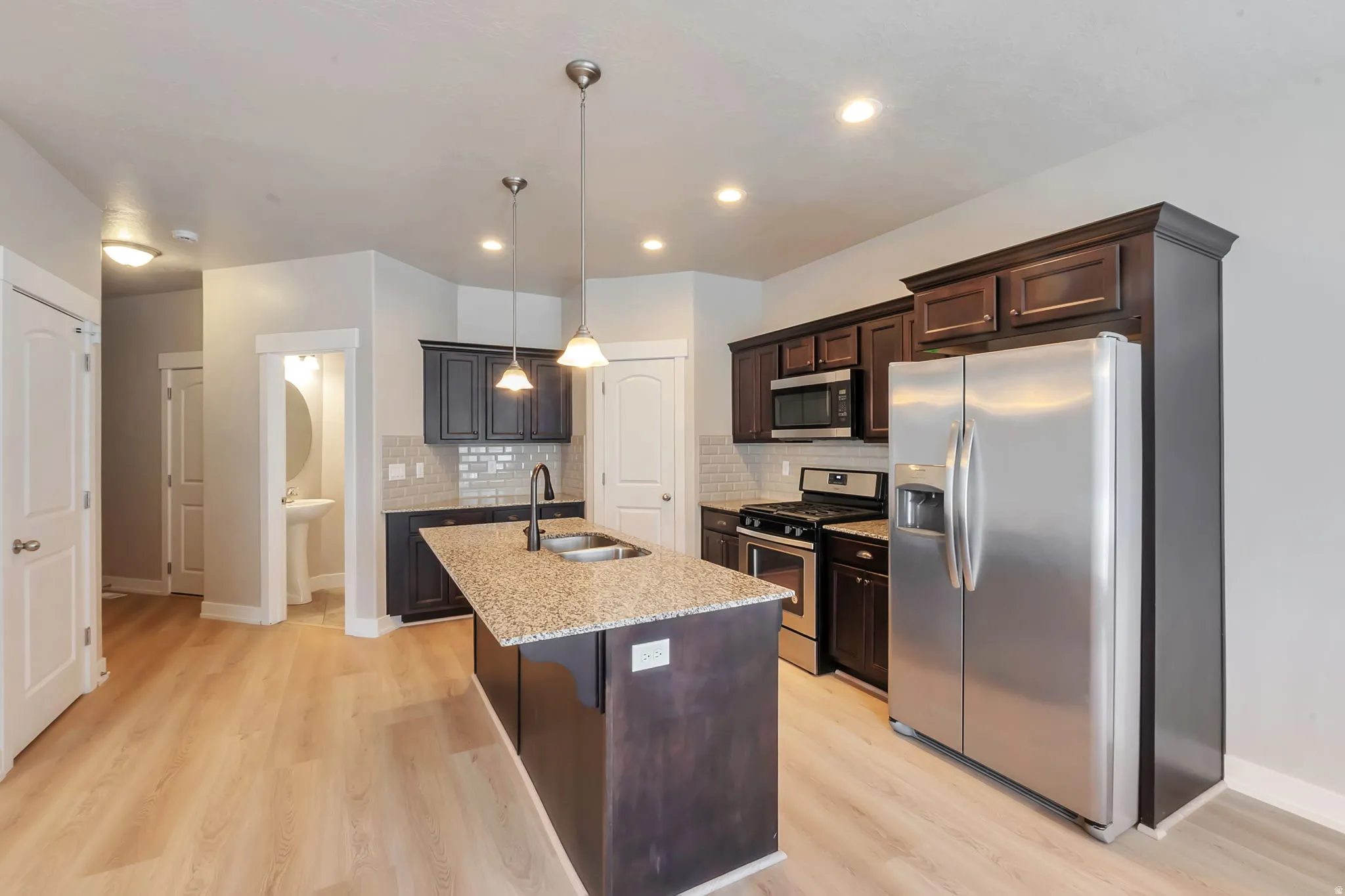 Kitchen with Island, stainless steel appliances and new LVP flooring