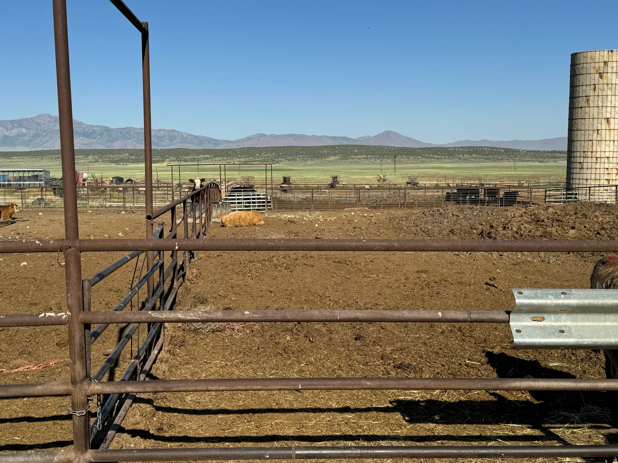 View of yard featuring a view of countryside, a mountain view, an outbuilding, and an exterior structure