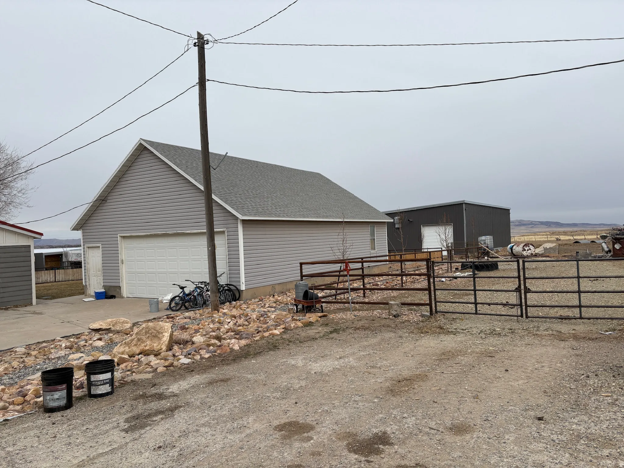 View of side of home featuring an outbuilding and a garage