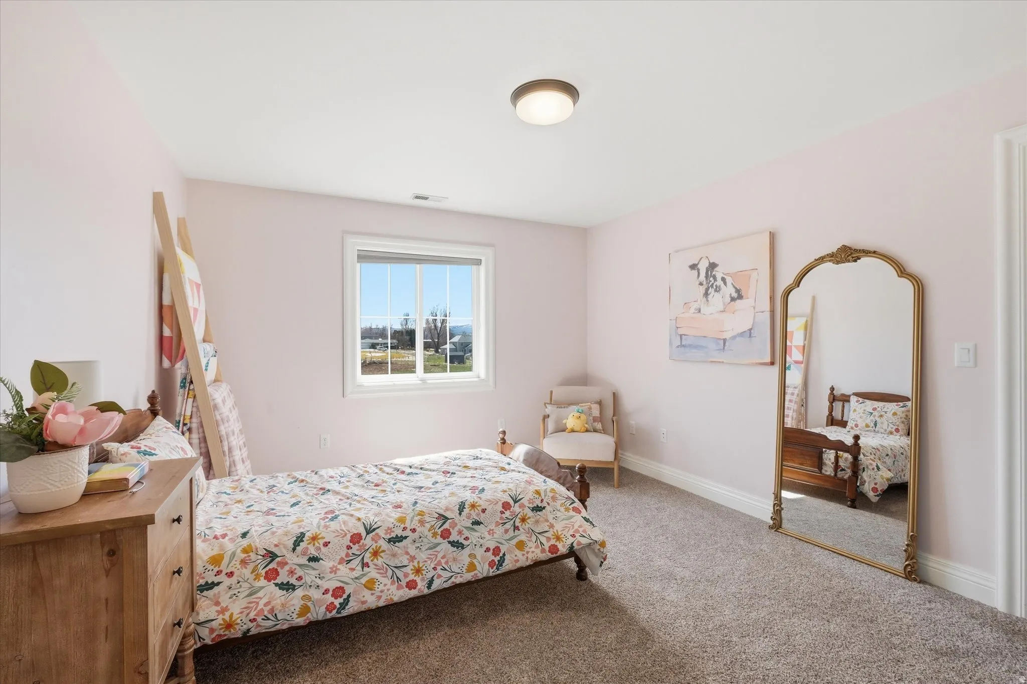 Bedroom with light colored carpet and baseboards