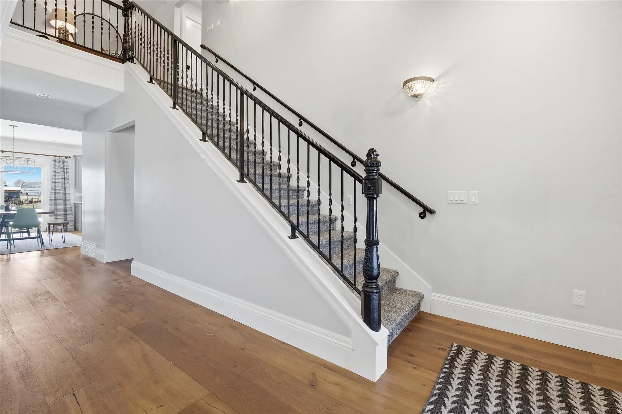 Stairway featuring hardwood / wood-style flooring and a high ceiling, Custom designer railing