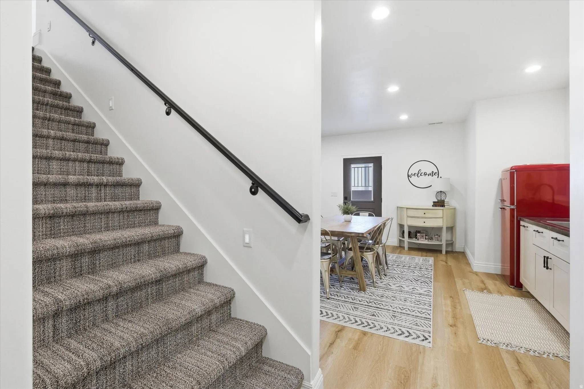 Staircase featuring wood finished floors and recessed lighting