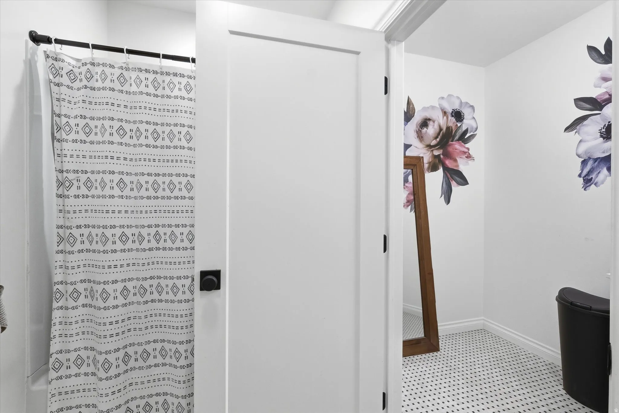 Bathroom featuring curtained shower and baseboards