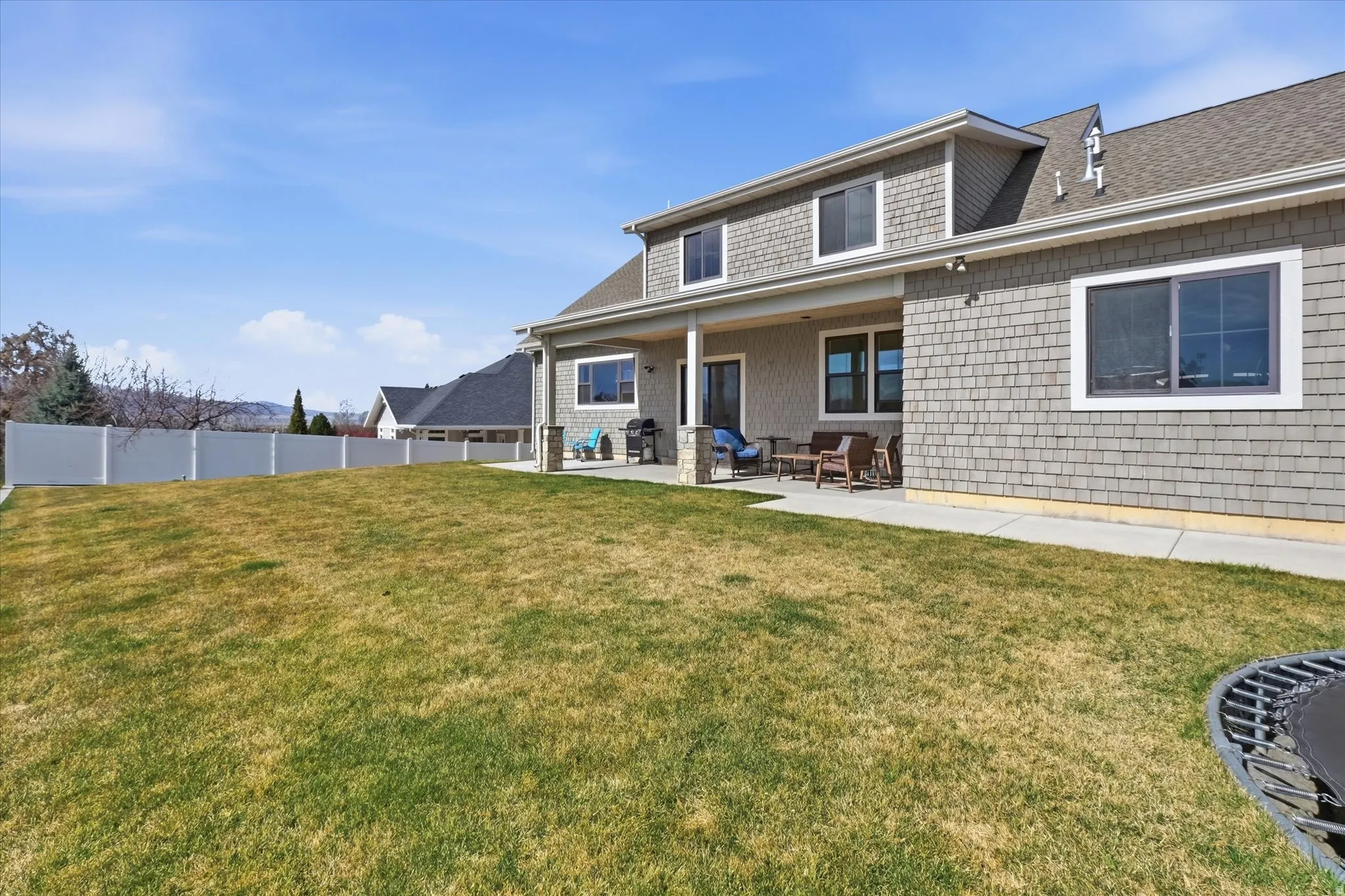 Back of property featuring a patio area and a shingled roof