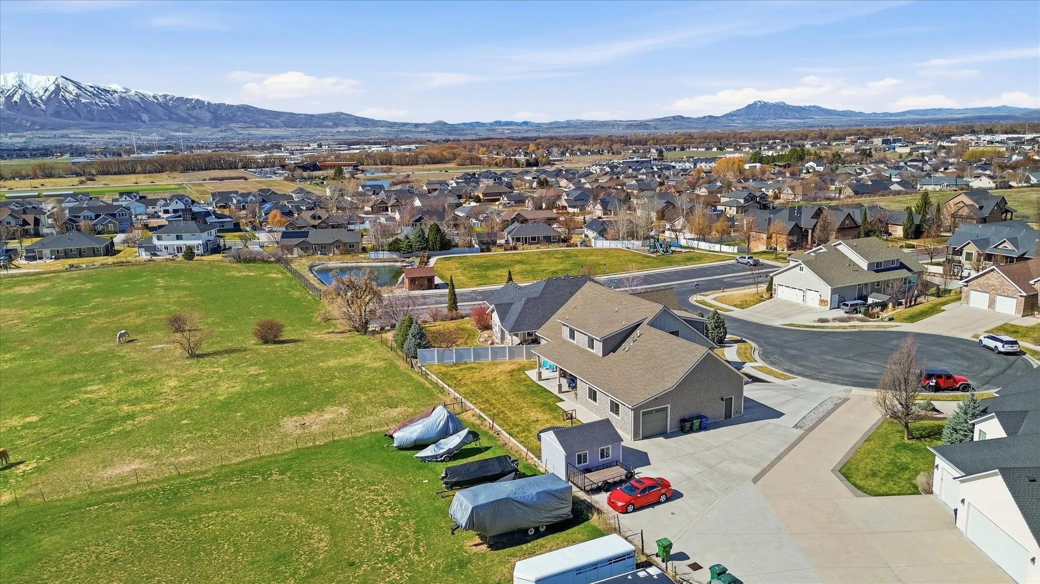 Aerial view of residential area with a mountain backdrop - City Park at the end of the street