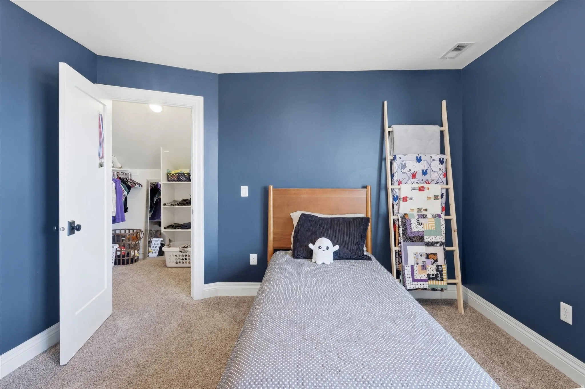 Bedroom featuring baseboards and light colored carpet