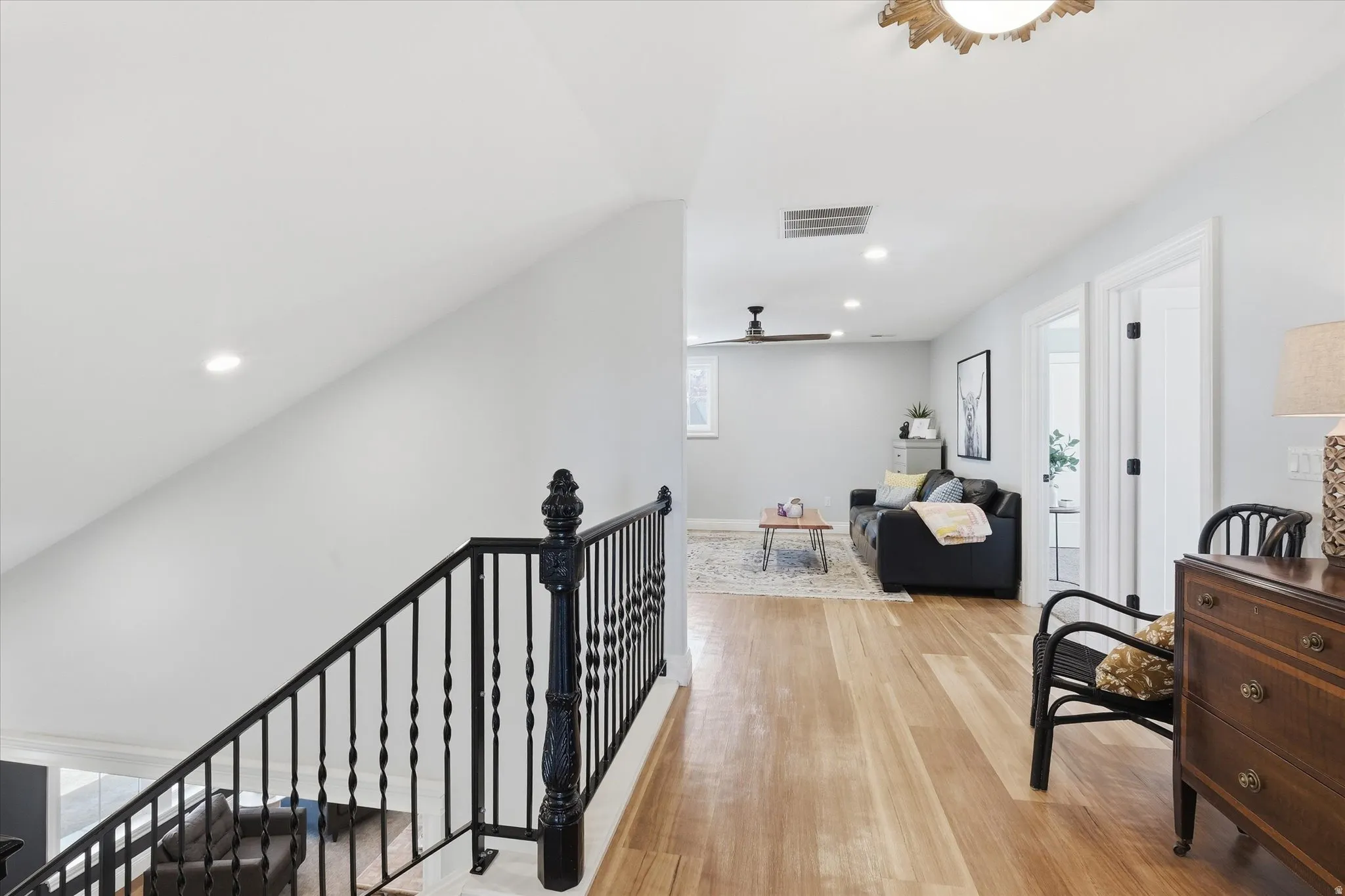 Corridor featuring an upstairs landing, leading to 4 bedrooms and family room