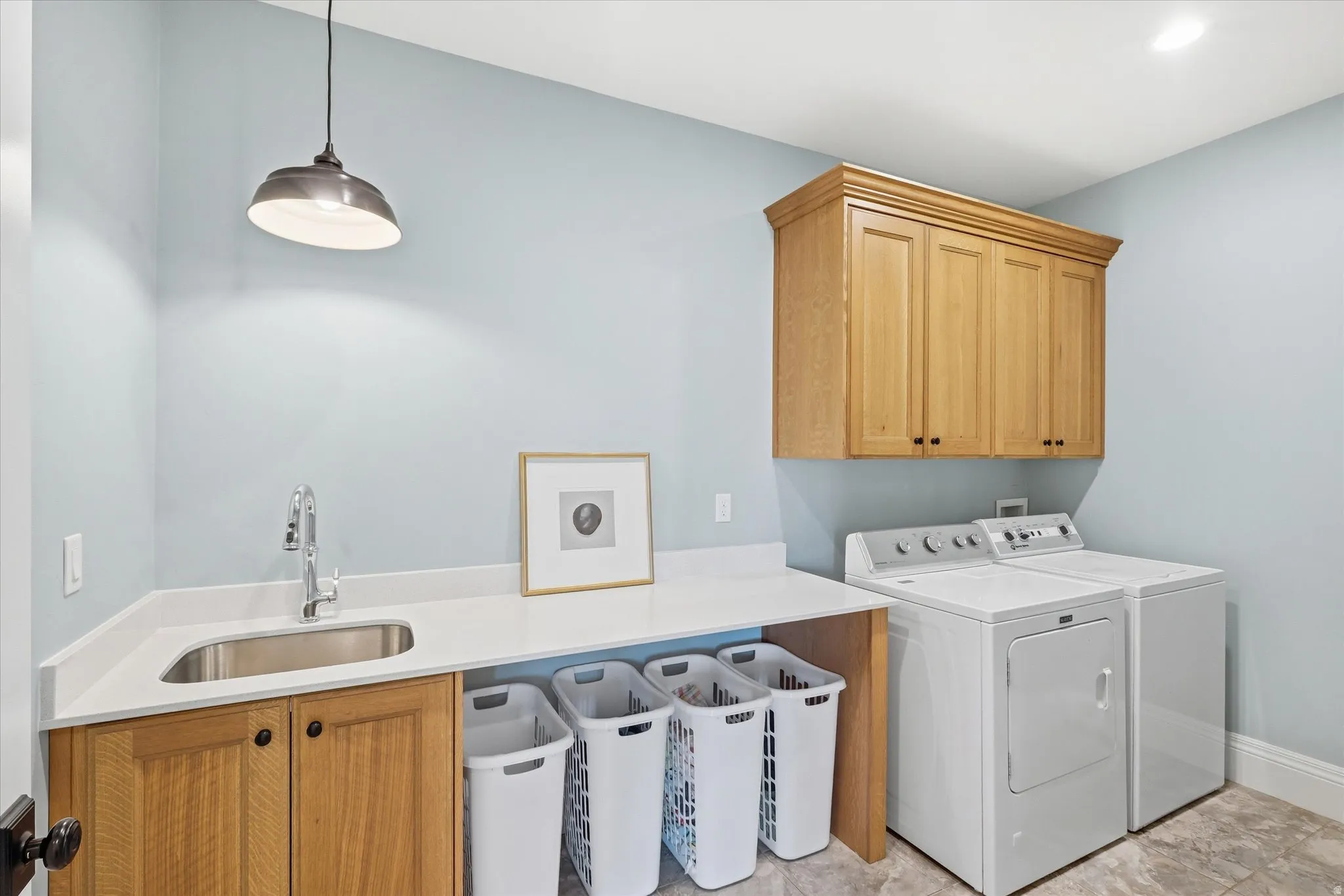 Laundry area with cabinet space and separate washer and dryer