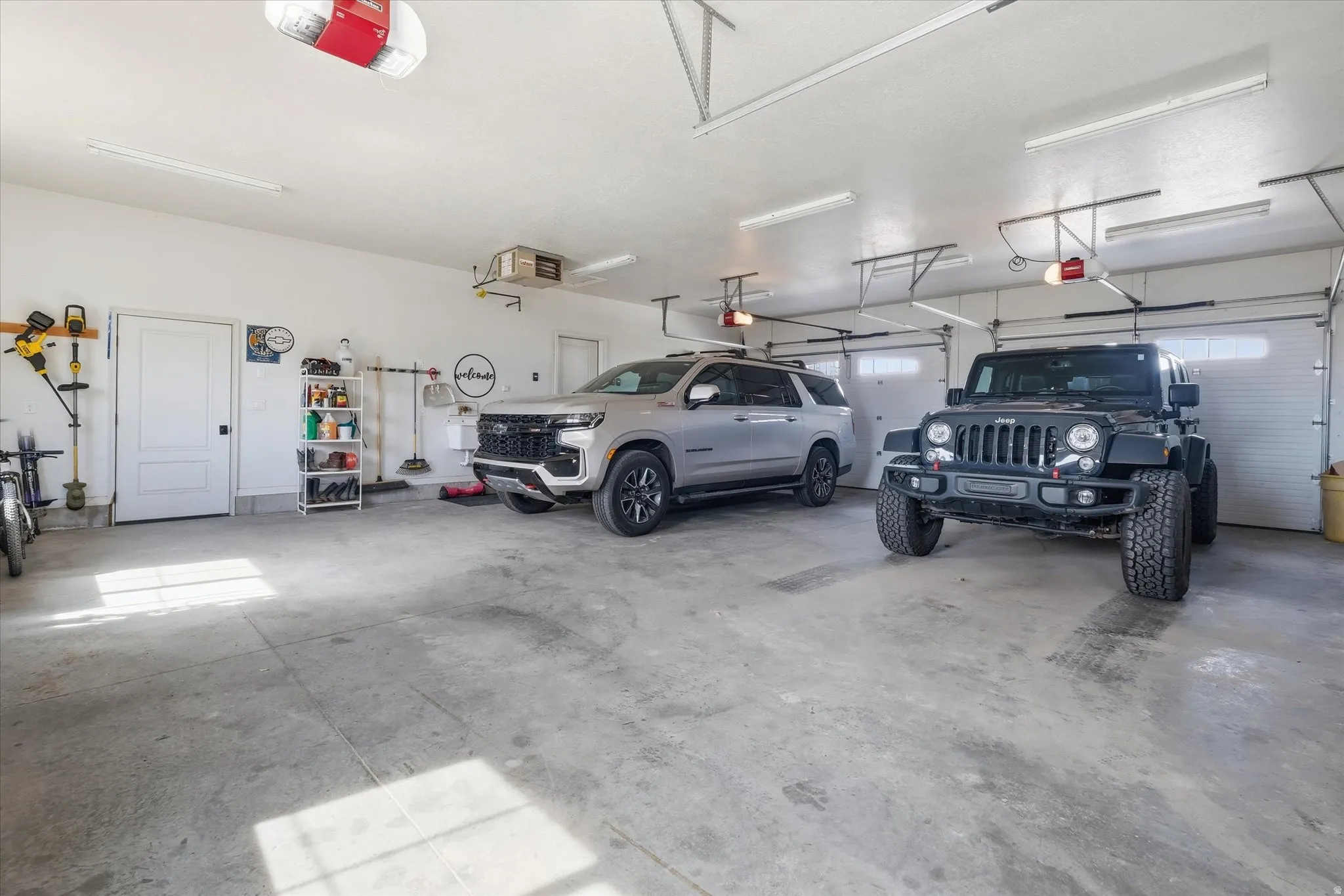 Garage featuring a garage door opener and a heating unit