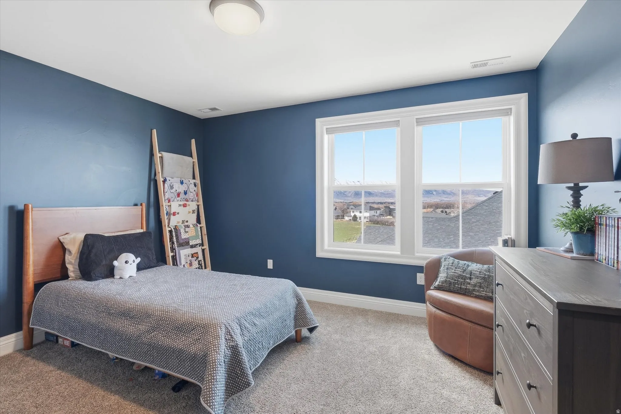 Bedroom featuring light colored carpet and baseboards