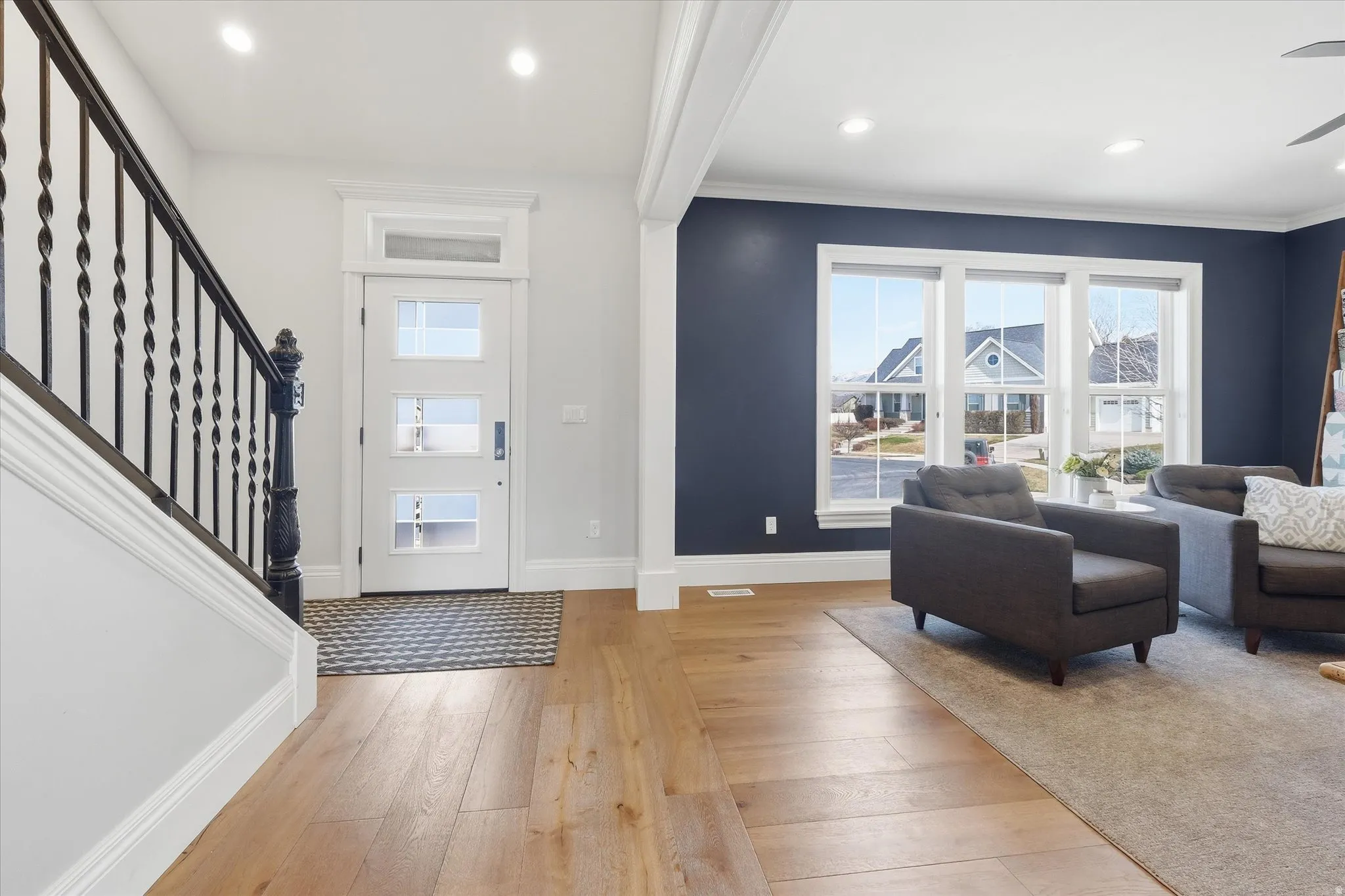 Entrance foyer featuring light wood-type flooring, recessed lighting, ceiling fan, and crown molding
