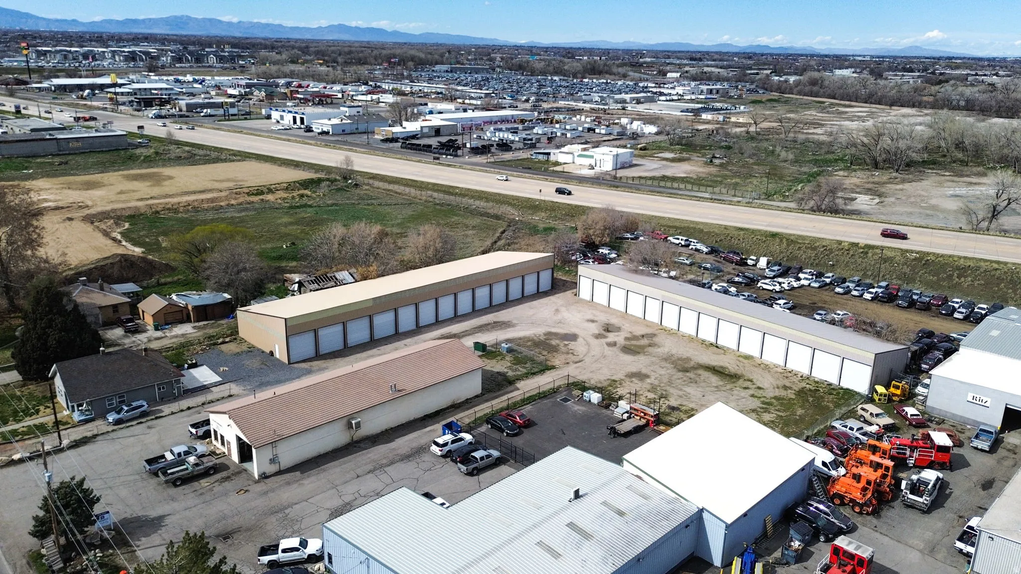 Aerial view of industrial structures and a mountain backdrop
