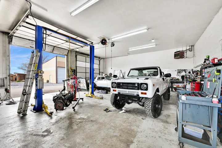 Garage featuring a heating unit and a workshop area