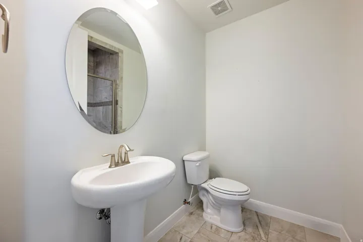 Bathroom with toilet and baseboards