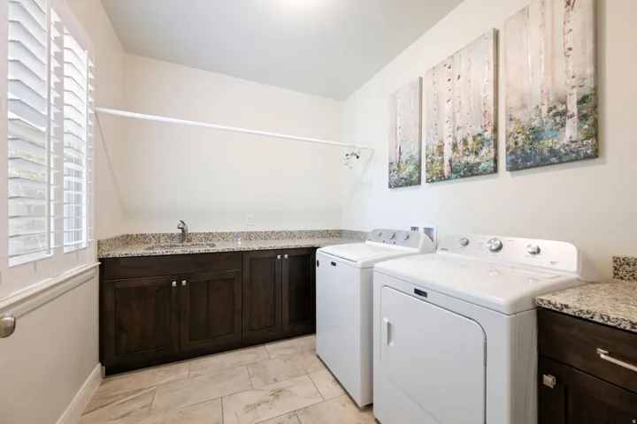 Laundry area with cabinet space and washing machine and dryer