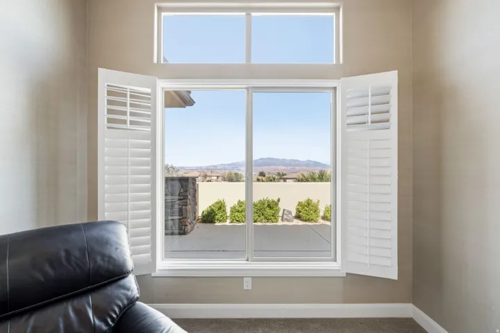 Sitting room with carpet flooring, a mountain view, and healthy amount of natural light