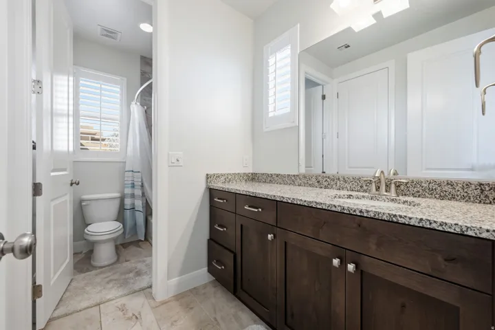 Bathroom with vanity and curtained shower
