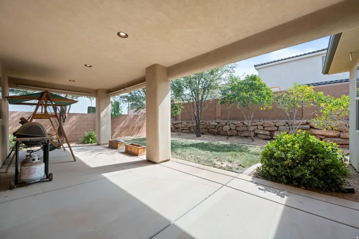 Fenced backyard featuring a patio and grilling area