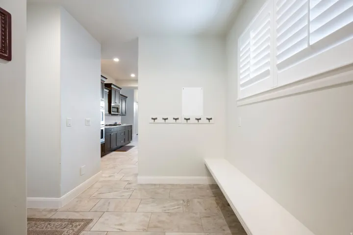 Corridor with baseboards and recessed lighting