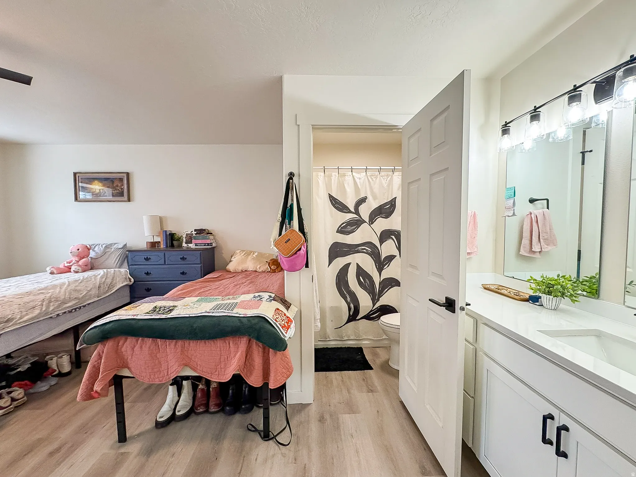 Bedroom featuring light wood-style floors and a sink