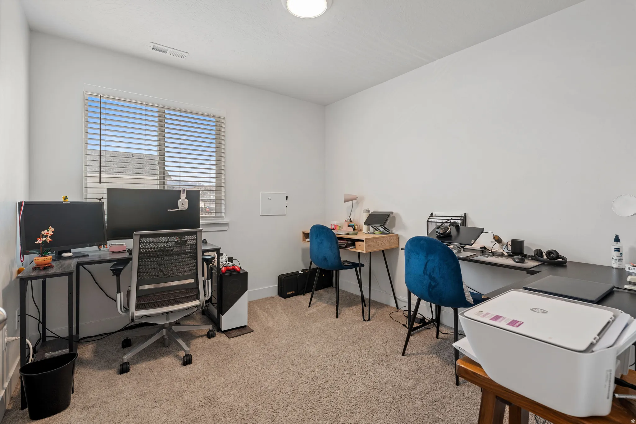 Office area with light colored carpet and baseboards
