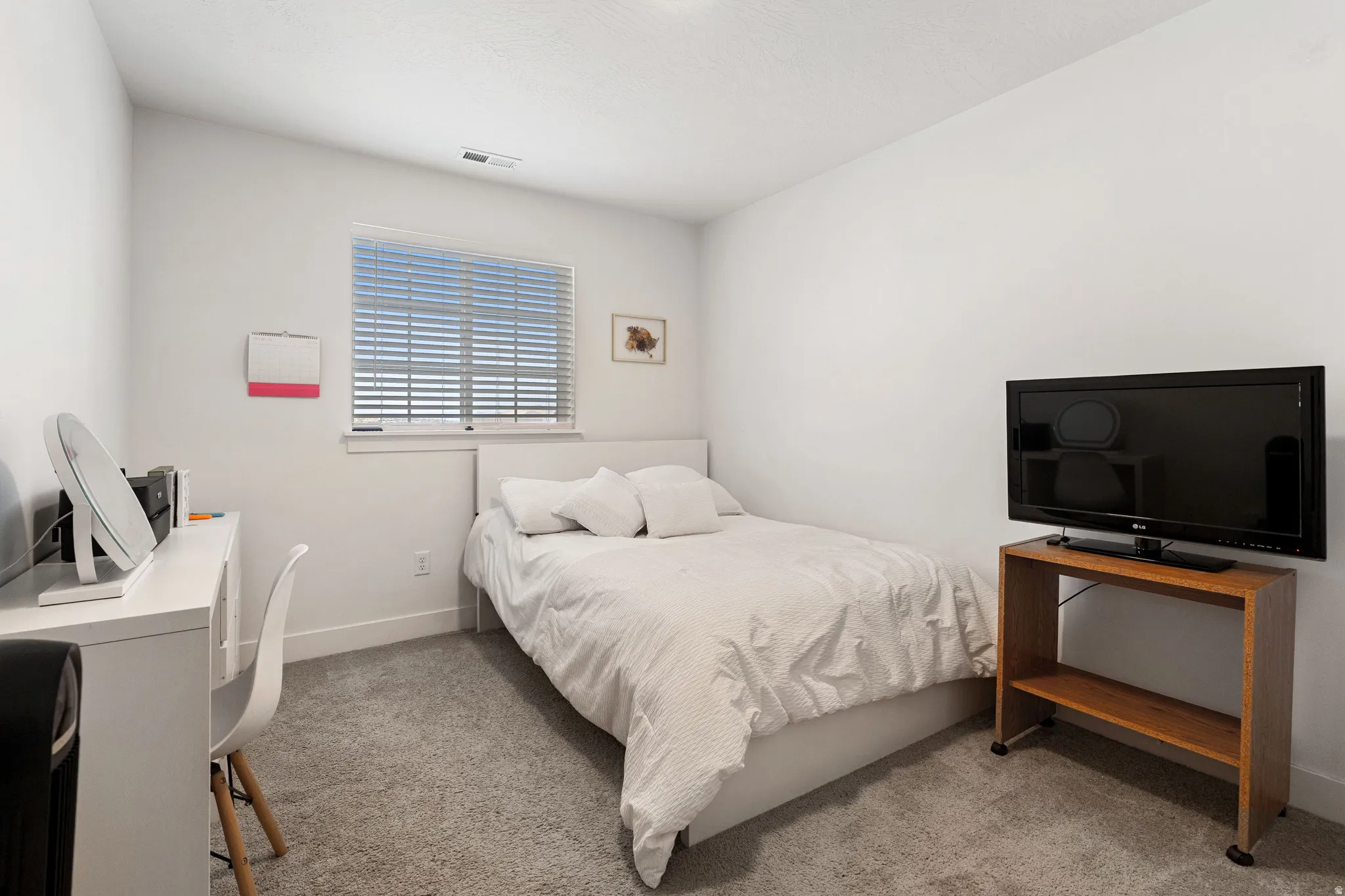 Bedroom featuring light colored carpet