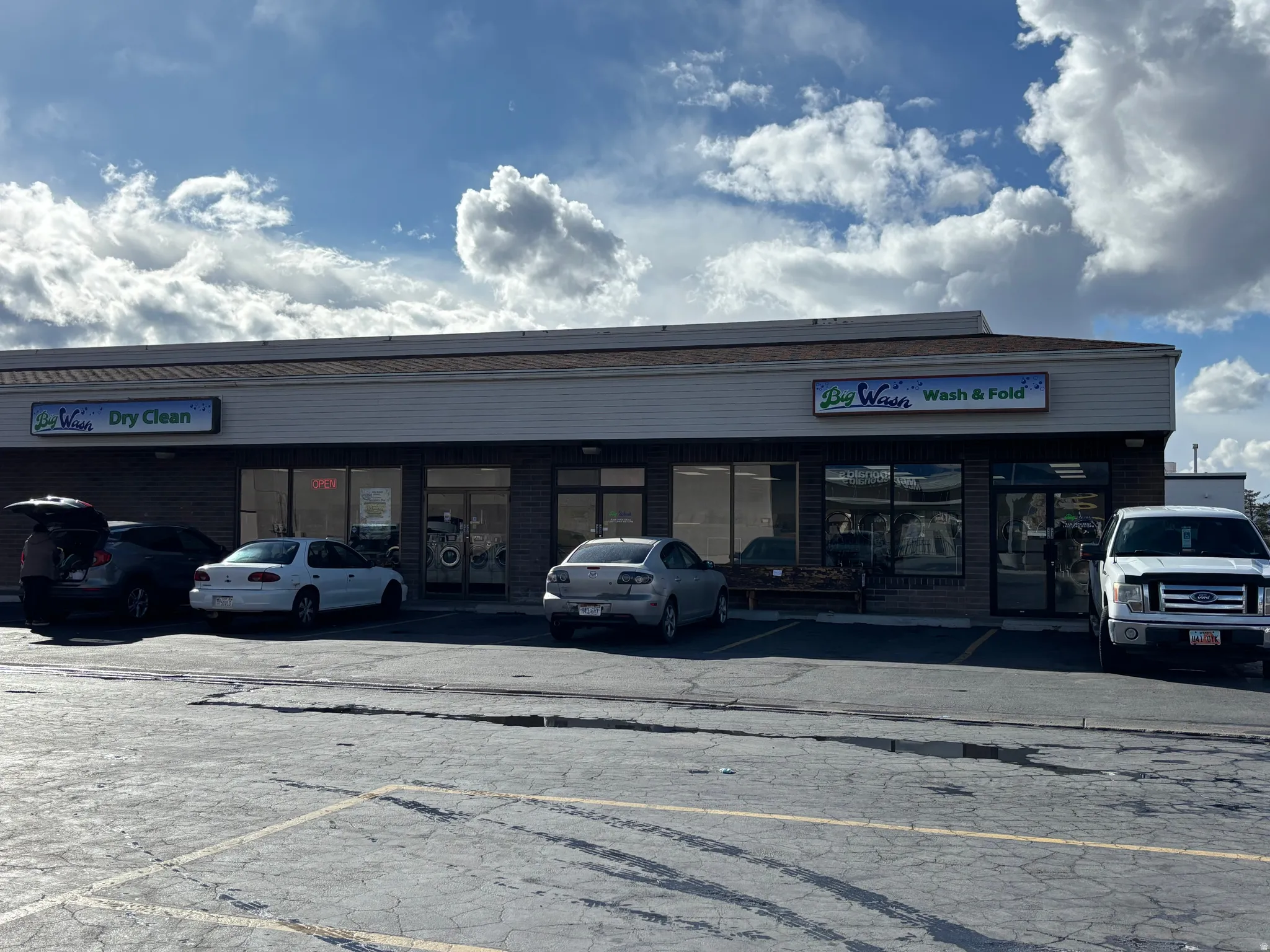 View of commercial property featuring uncovered parking