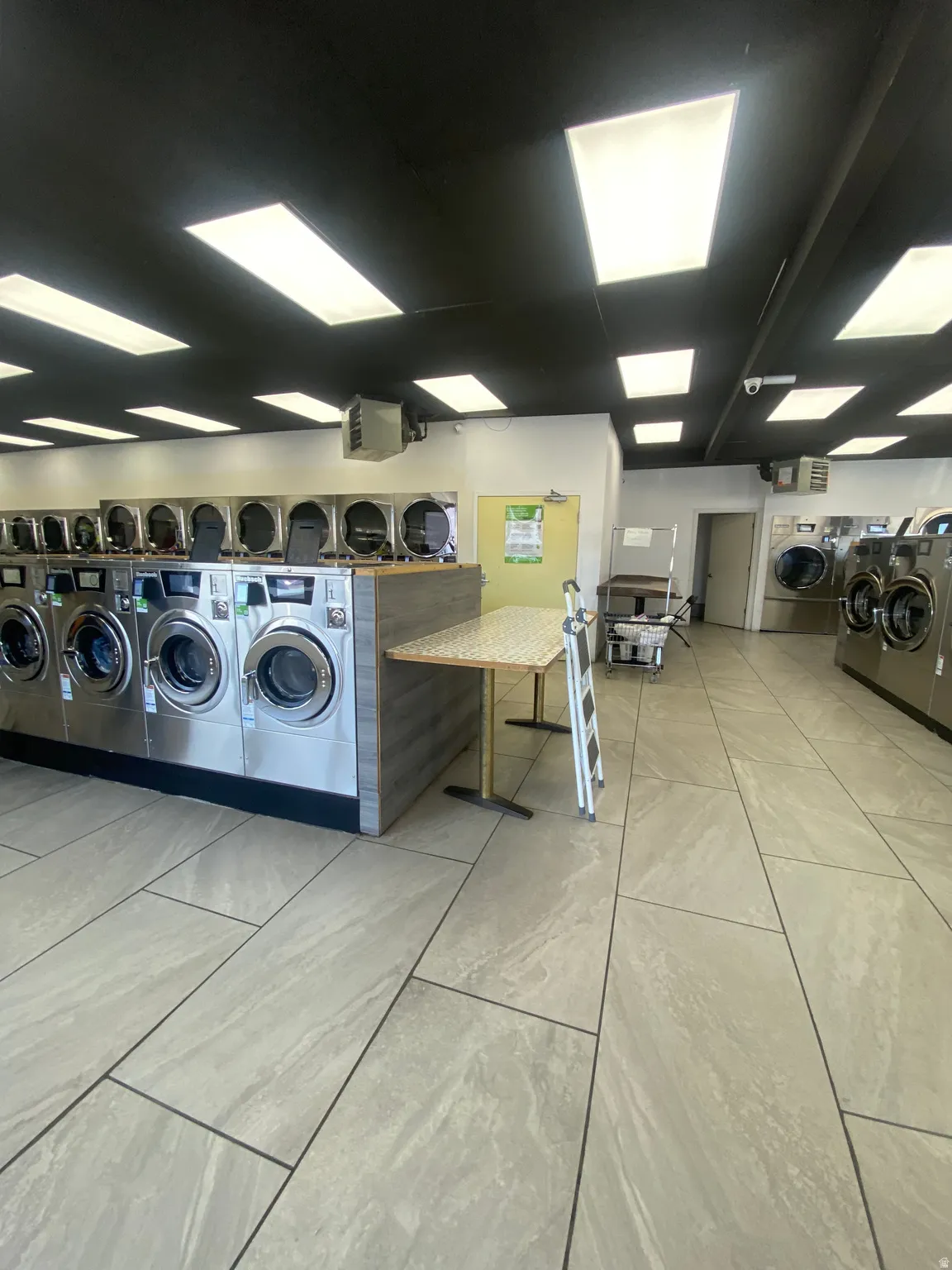 Shared laundry room featuring washing machine and dryer and a heating unit