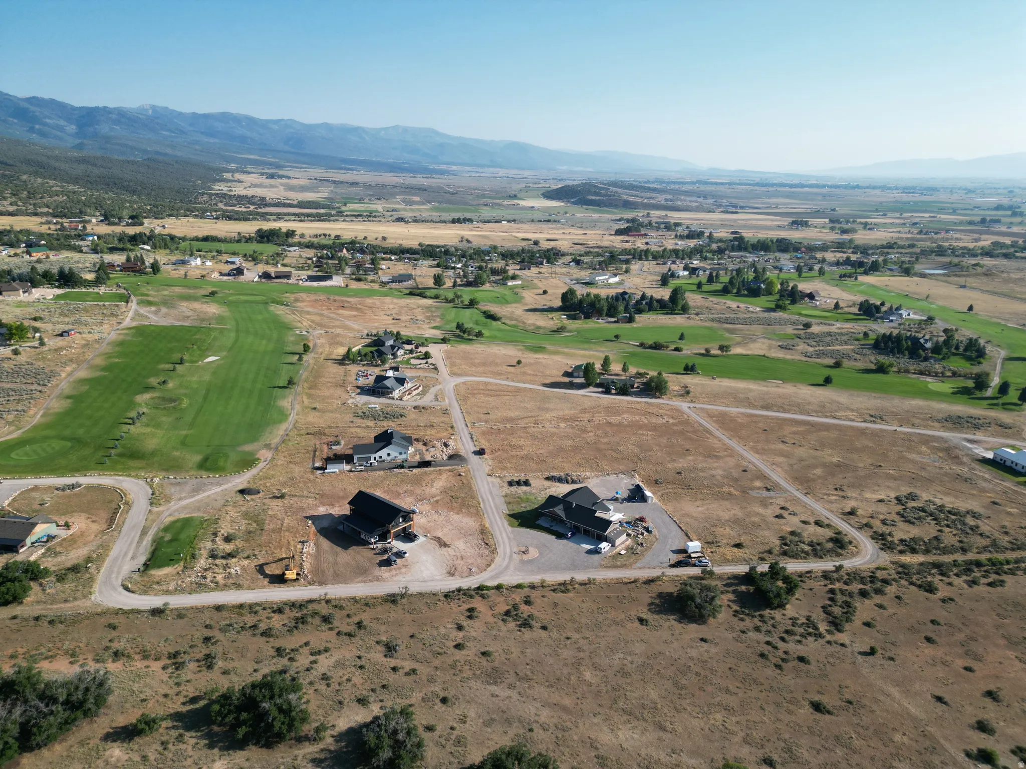 Aerial overview of property's location featuring a mountainous background