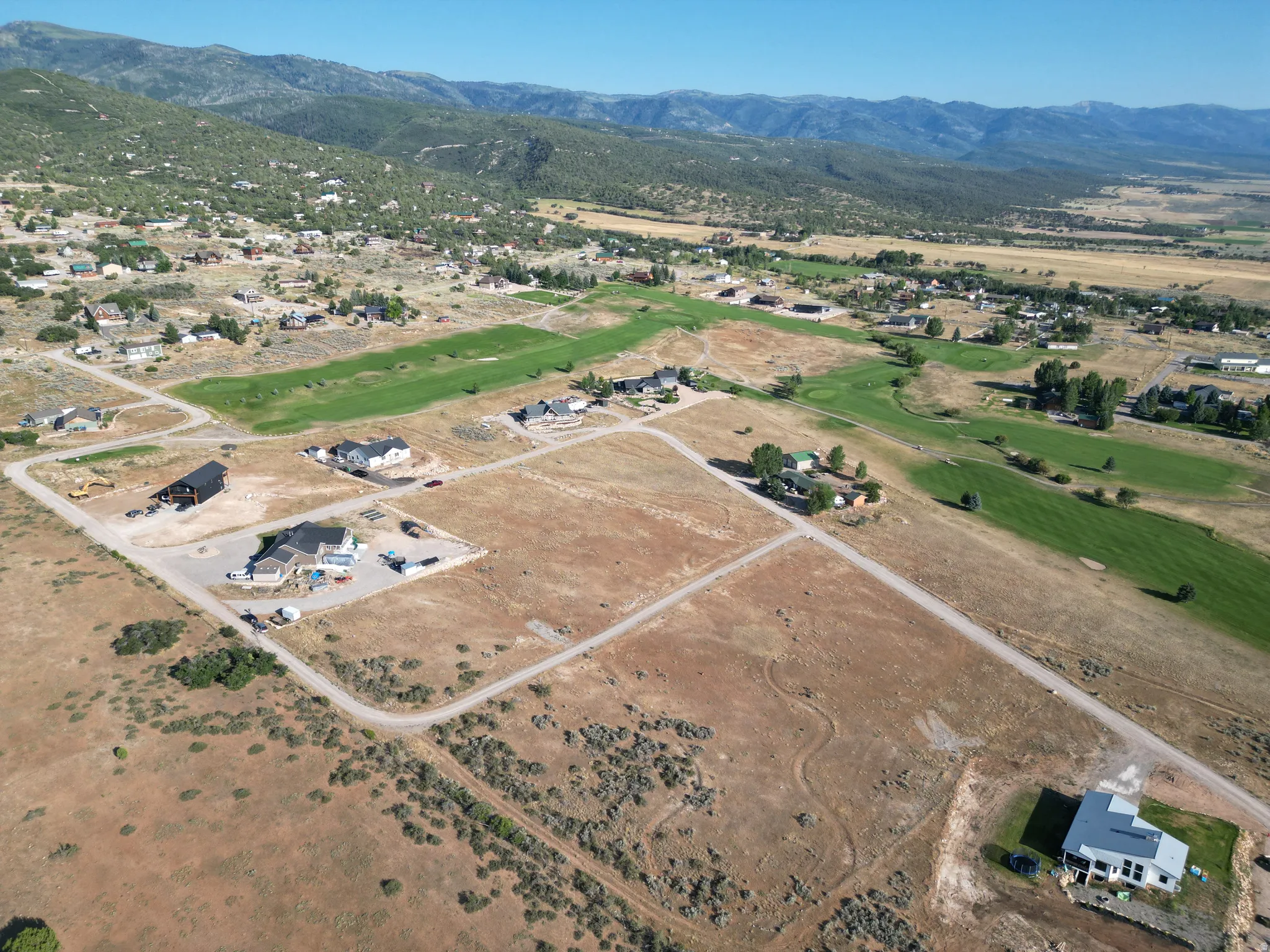 Aerial view of residential area featuring a mountainous background
