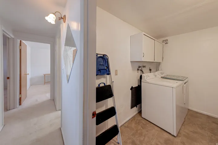 Laundry area featuring washer and dryer and cabinet space