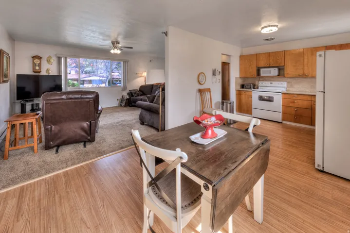 Dining area with light wood-style flooring and a ceiling fan