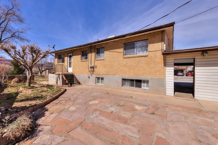 Rear view of house with brick siding