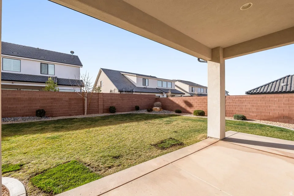 Fenced backyard with a patio