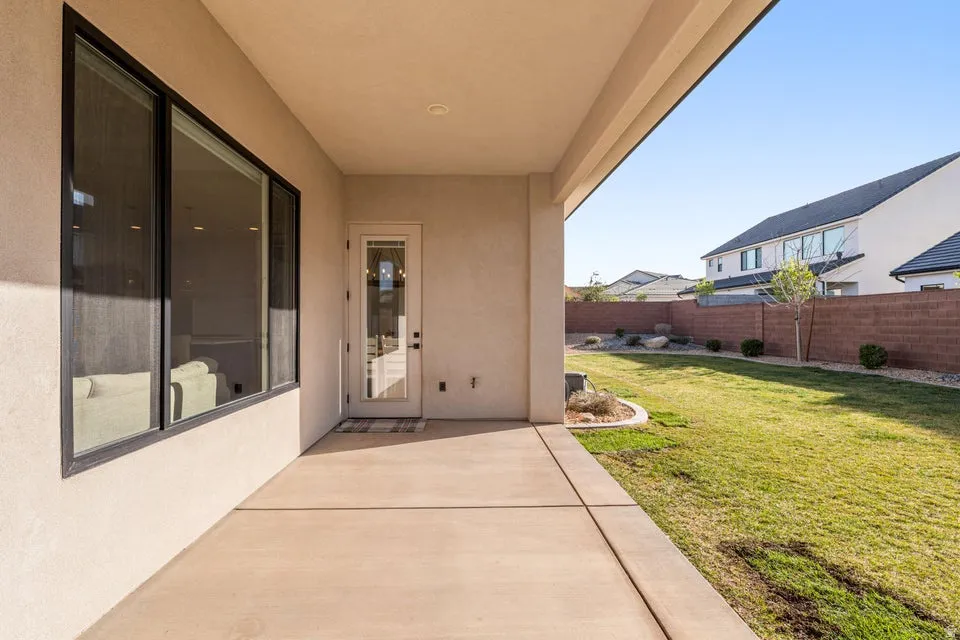 Property entrance featuring stucco siding and a patio