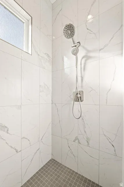 Full bath featuring a tile shower